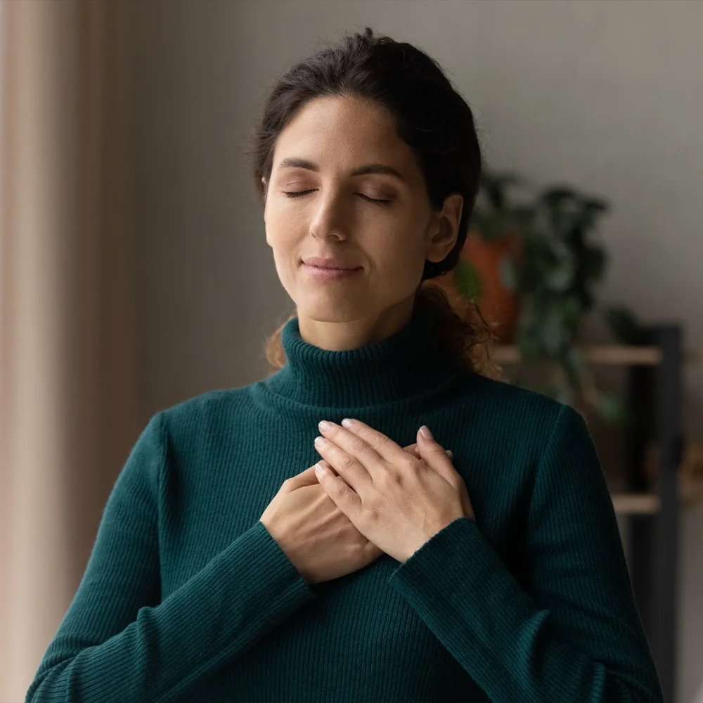 Woman standing calmly with eyes closed